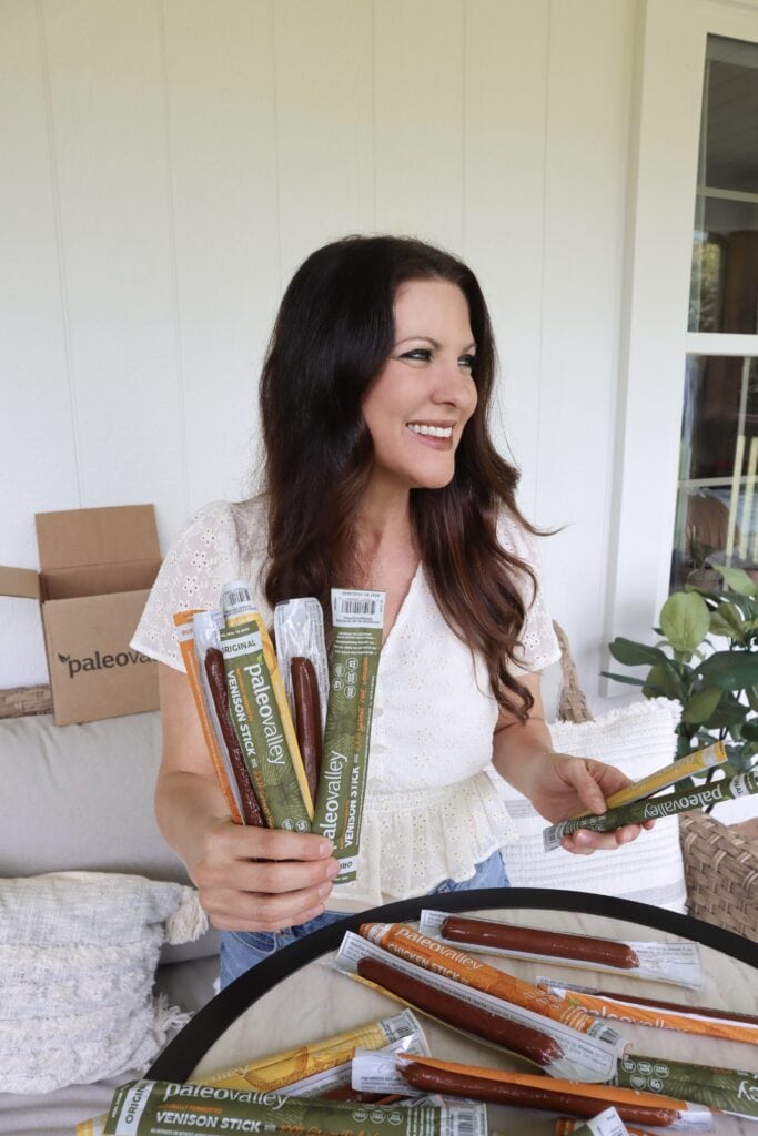 Christina with her favorite snack, Paleovalley Meat Sticks